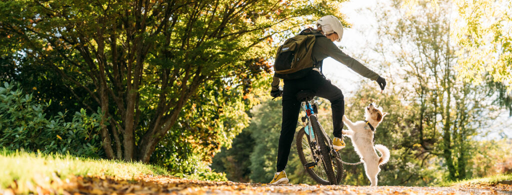 Header 0000s 0002 Mfi Woman Biking With Dog